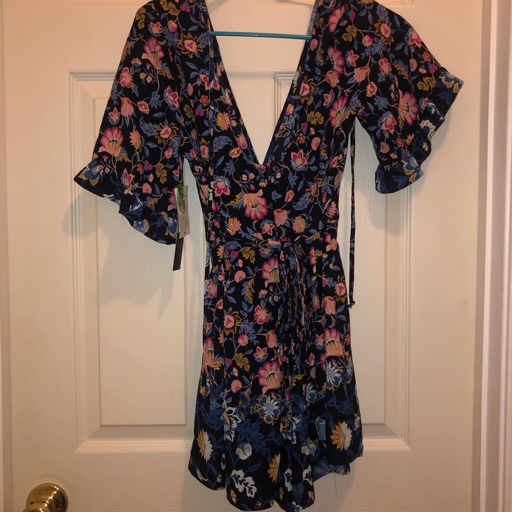 Floral romper with deep V and pockets.